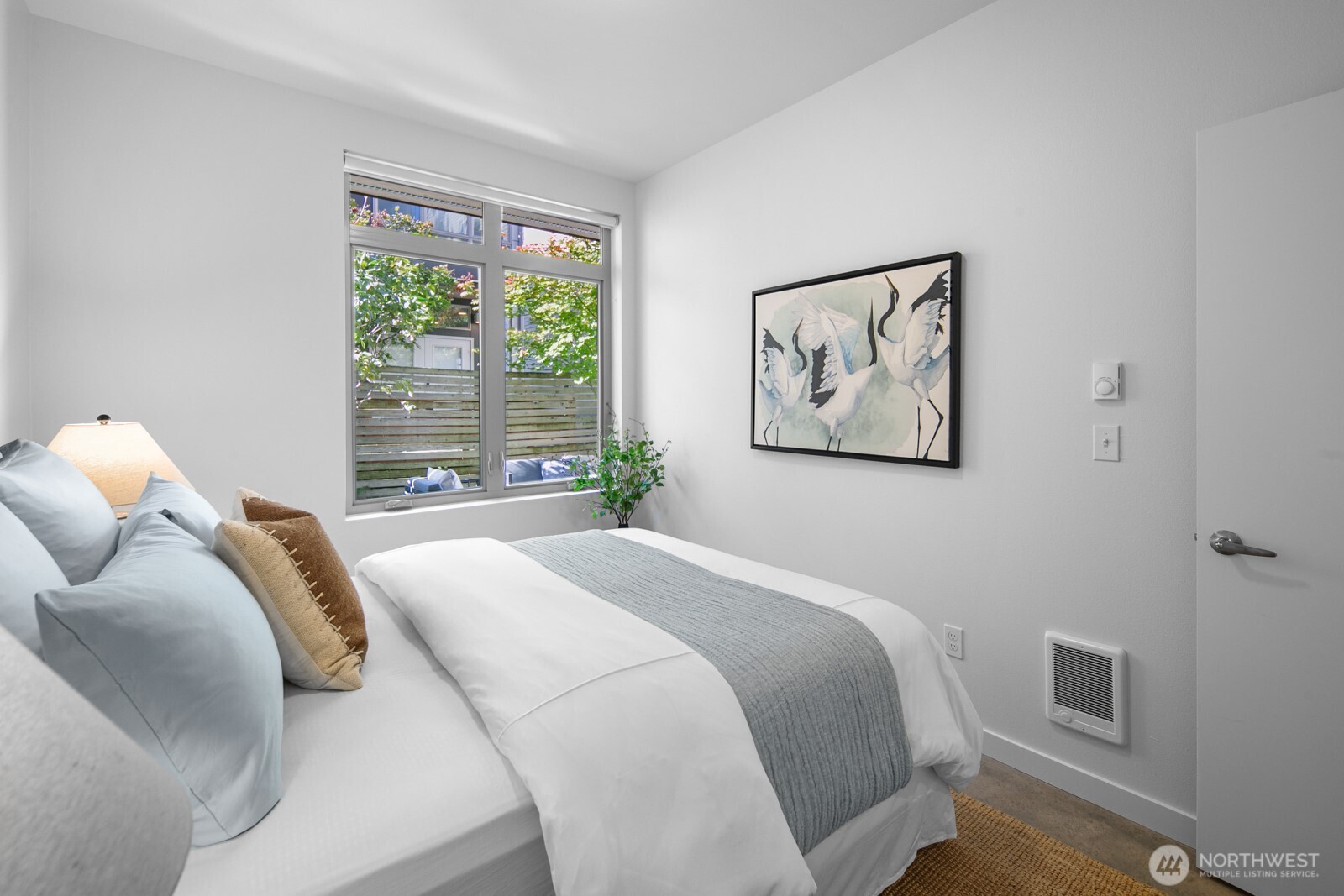 2808 14th Avenue West, Unit B Seattle, WA 98119 - Photo 25 of 39 a bedroom with a large bed and a window