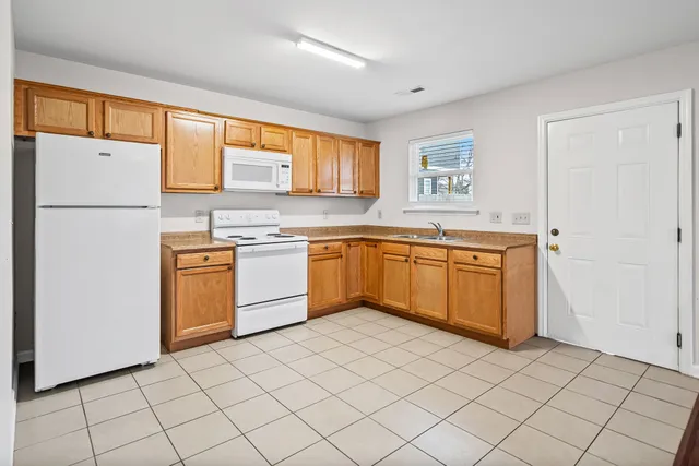 a kitchen with a sink a window and stainless steel appliances