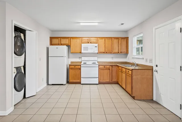 a kitchen with a white stove top oven and sink