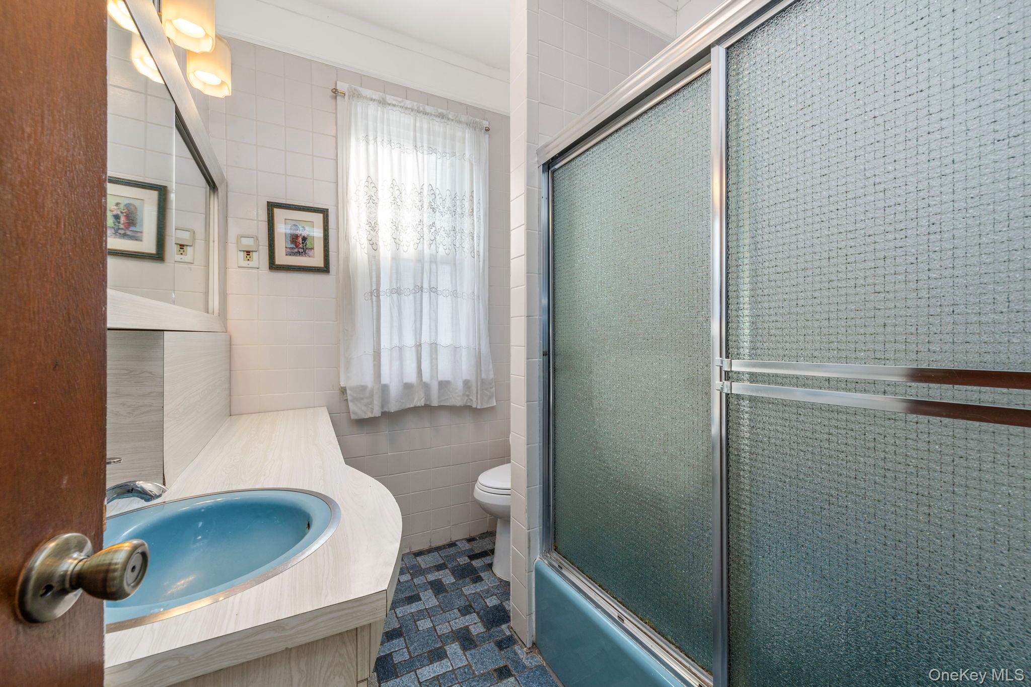 92-69 220th Street Queens, NY 11428 - Photo 11 of 33 a bathroom with a sink and toilet