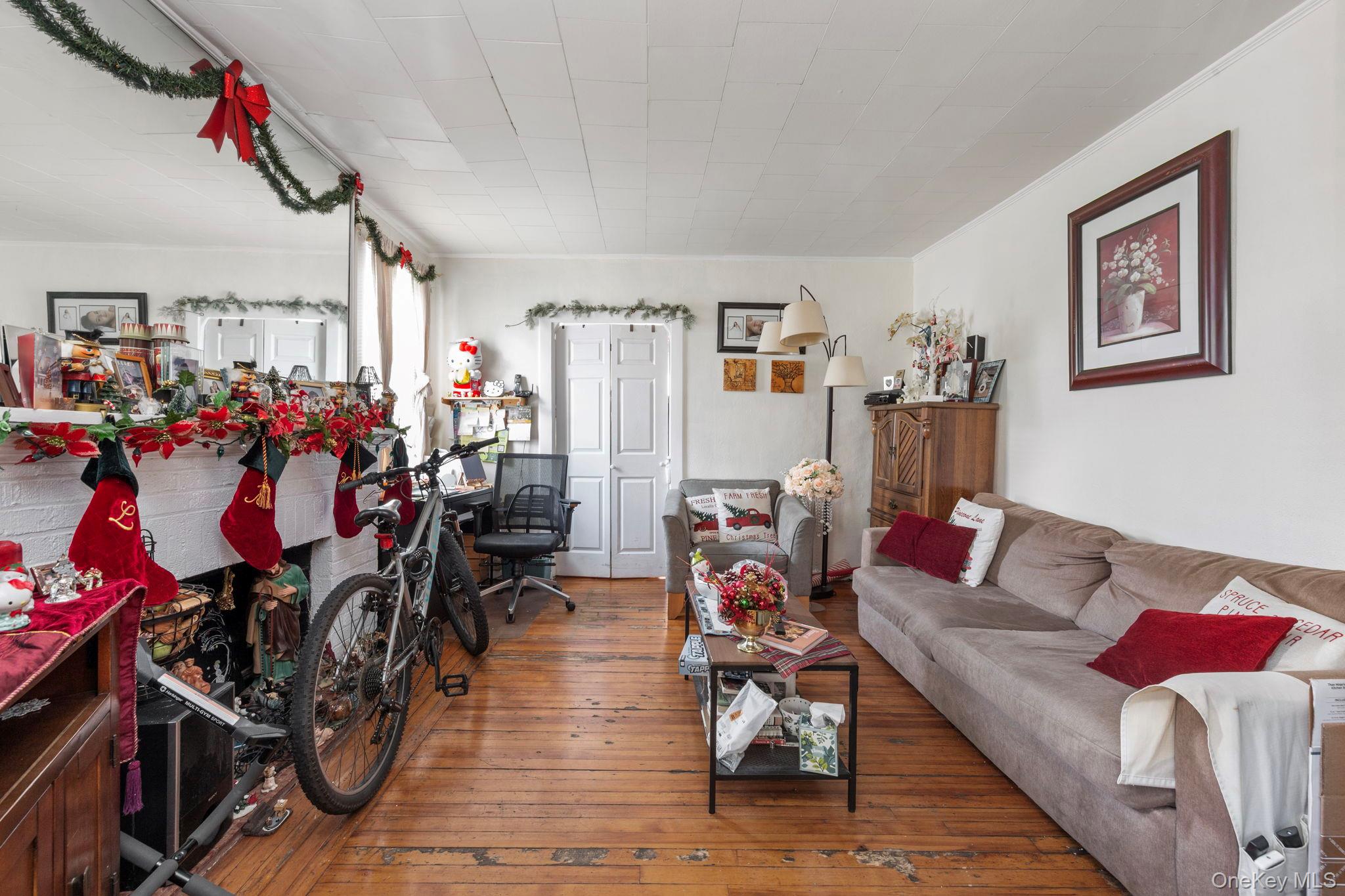92-69 220th Street Queens, NY 11428 - Photo 14 of 33 a living room with lots of furniture and clothes