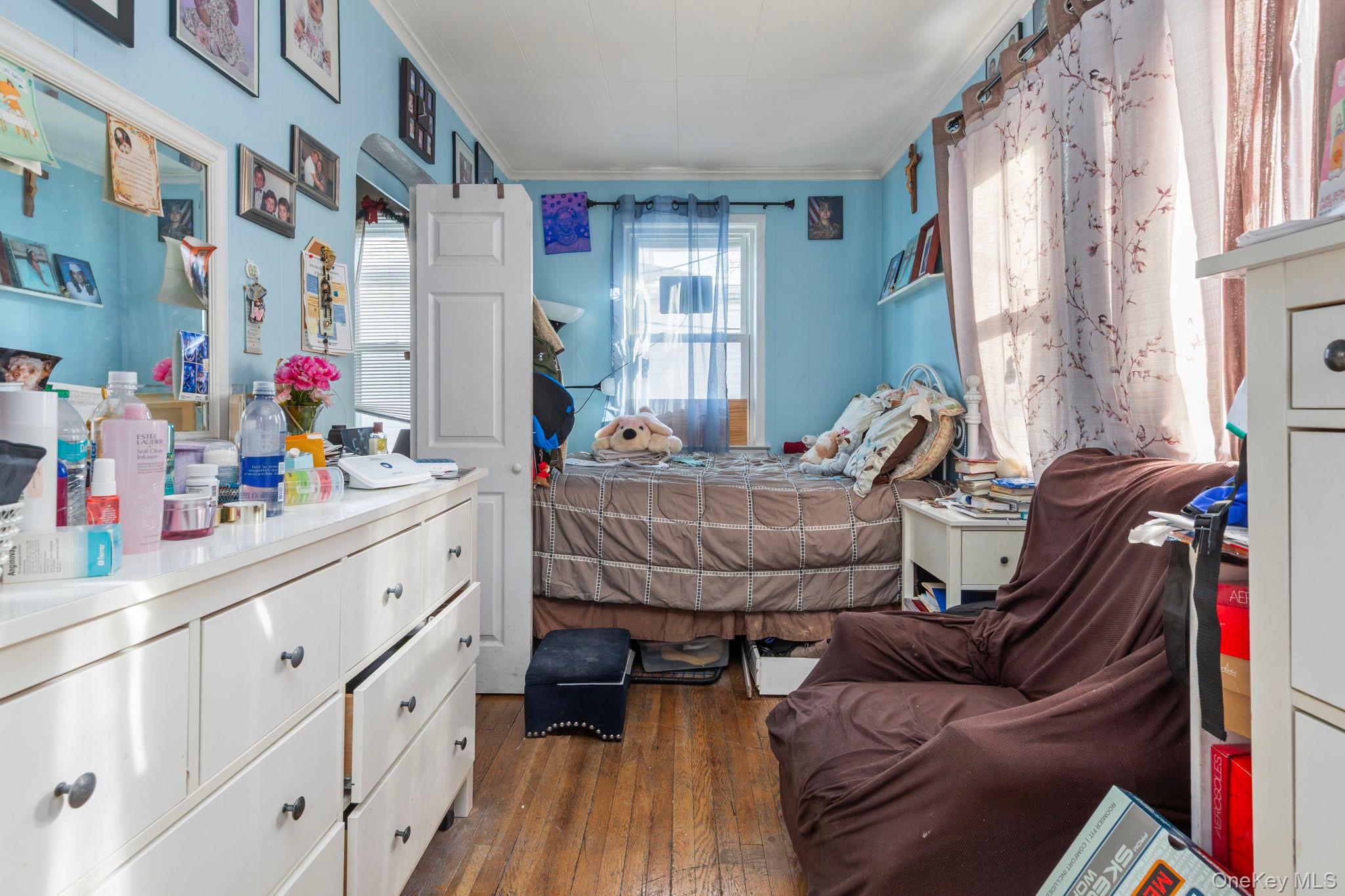 92-69 220th Street Queens, NY 11428 - Photo 16 of 33 a bedroom with furniture and a window