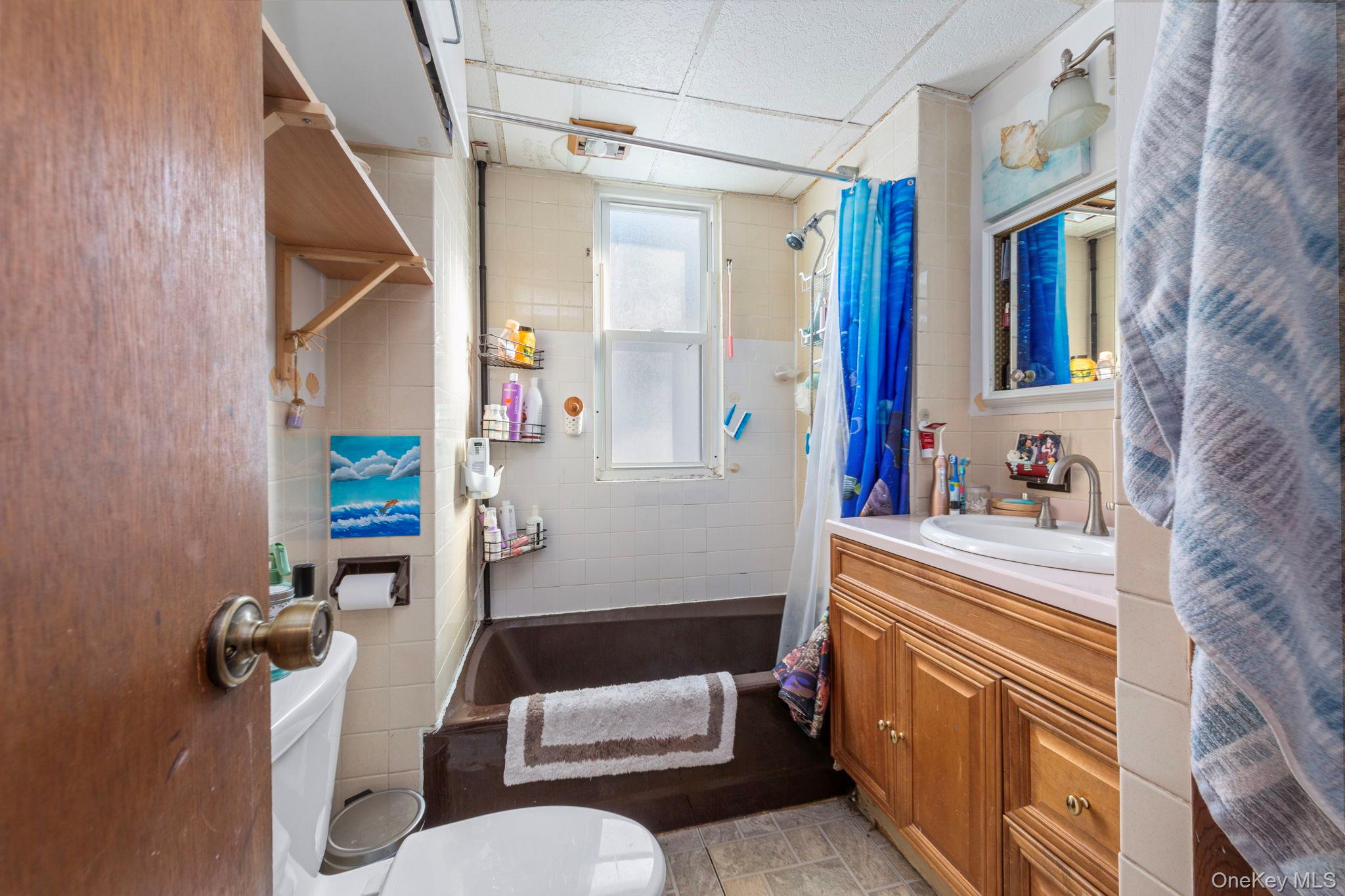 92-69 220th Street Queens, NY 11428 - Photo 18 of 33 a bathroom with a sink toilet and shower