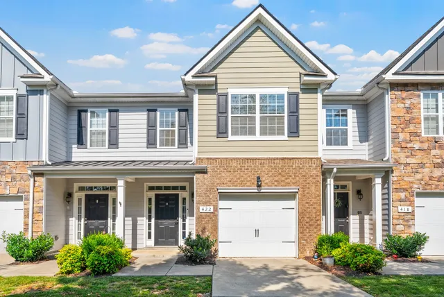 front view of brick house with a yard