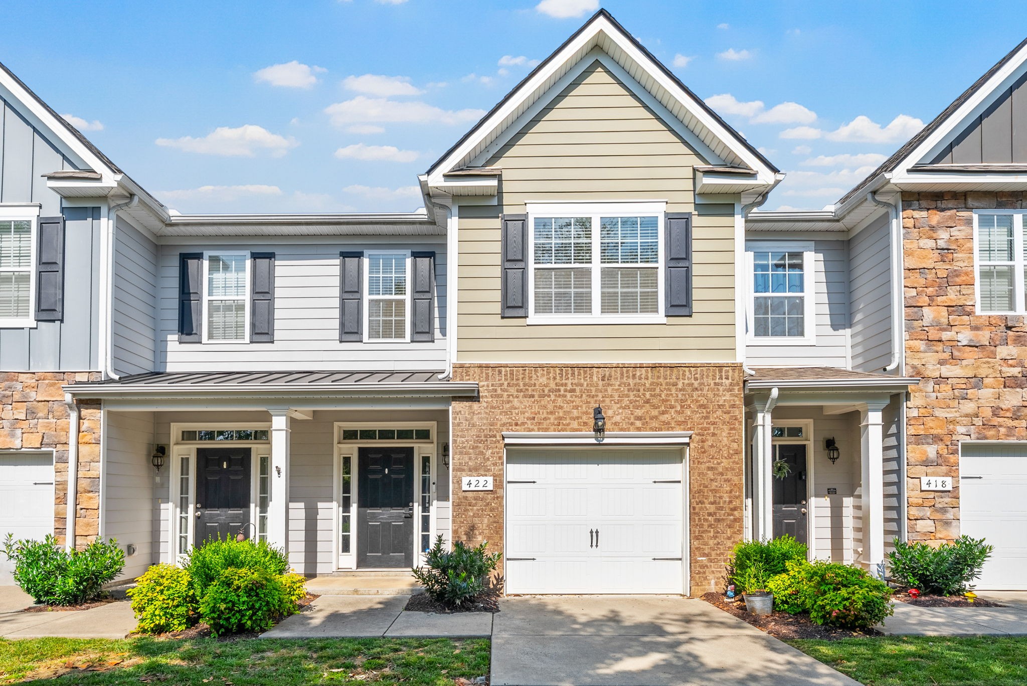front view of brick house with a yard