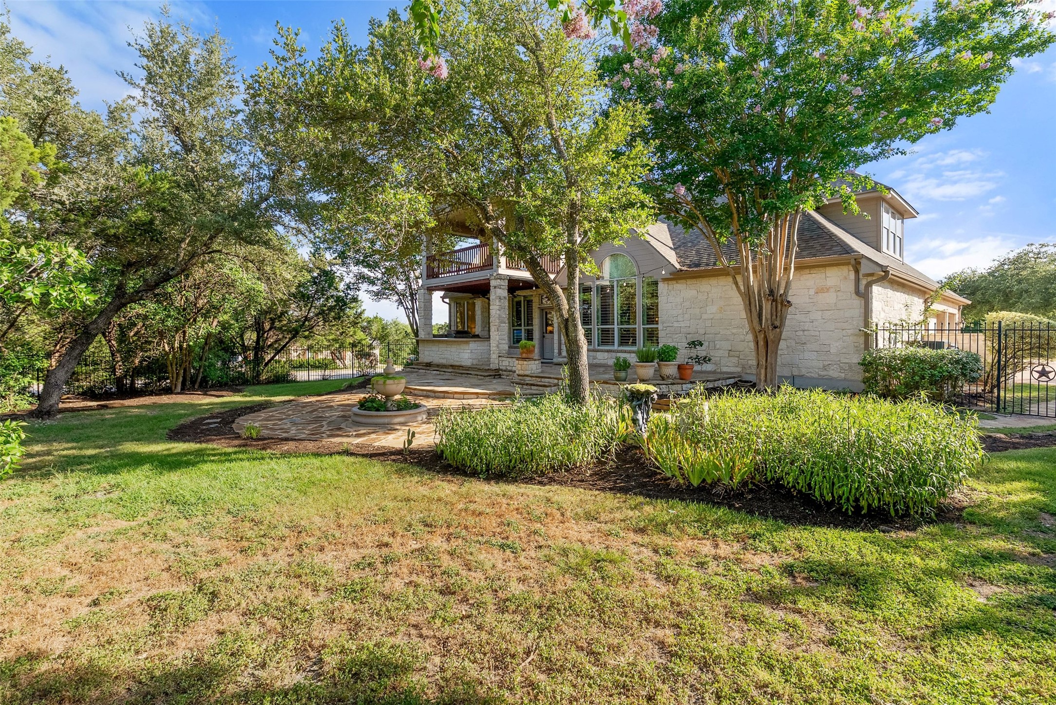 8215 Dark Ridge Cove Austin, TX 78737 - Photo 36 of 40 Mature trees and vibrant landscaping frame this lush backyard with room to expand.