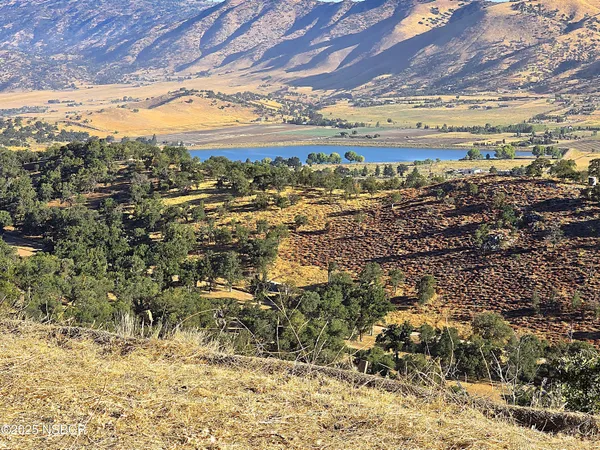 a view of a field with mountains in the background