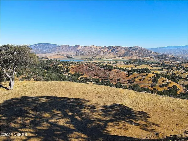 a view of mountain with sunset in background