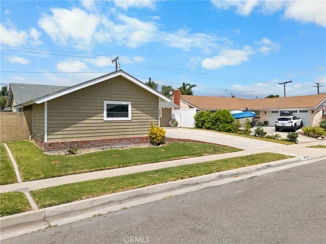 a kitchen with granite countertop a stove a sink and a refrigerator