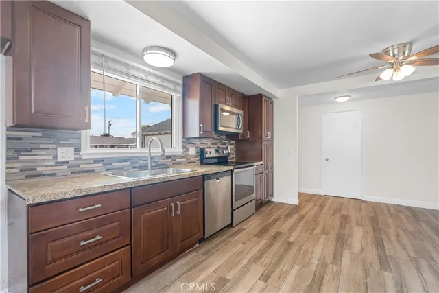 a kitchen with a refrigerator stove and sink