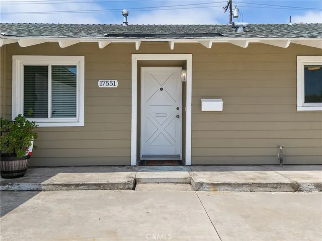 a kitchen with a refrigerator and a stove top oven