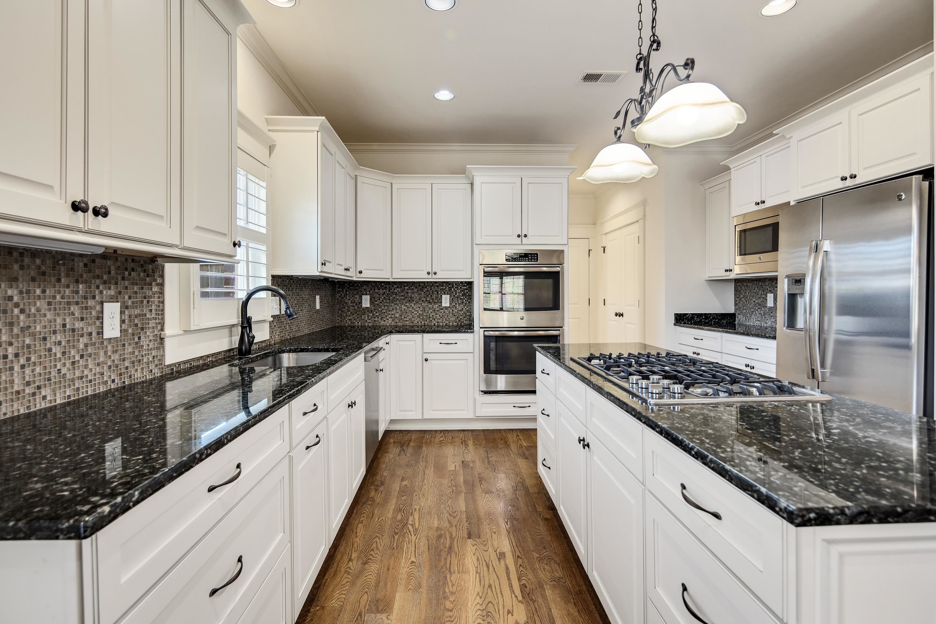 9110 Baynard Loop North Germantown, TN 38139 - Photo 14 of 40 a large kitchen with stainless steel appliances granite countertop a stove a sink dishwasher and a refrigerator