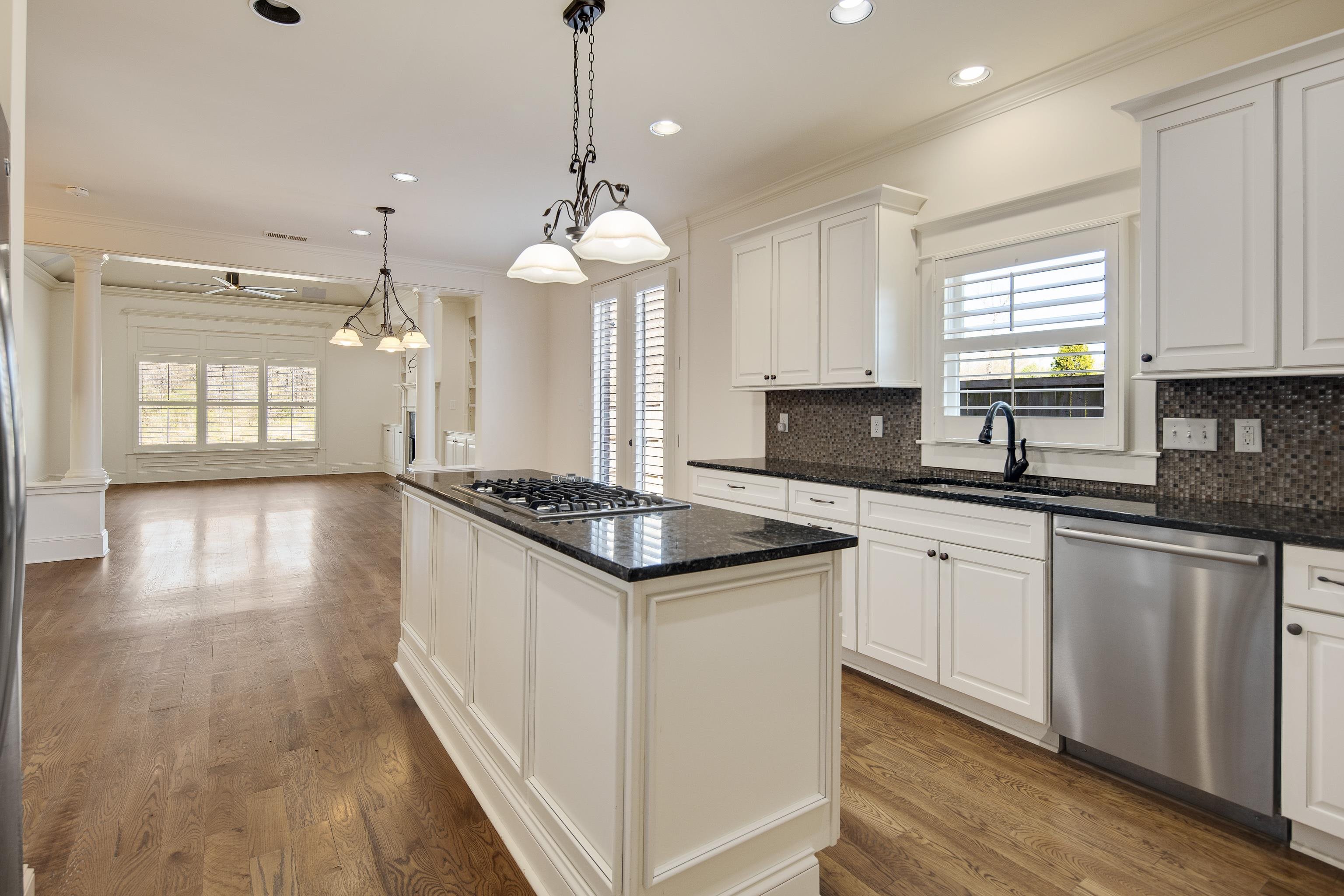 9110 Baynard Loop North Germantown, TN 38139 - Photo 15 of 40 a kitchen with stainless steel appliances granite countertop a sink a stove and a wooden floors