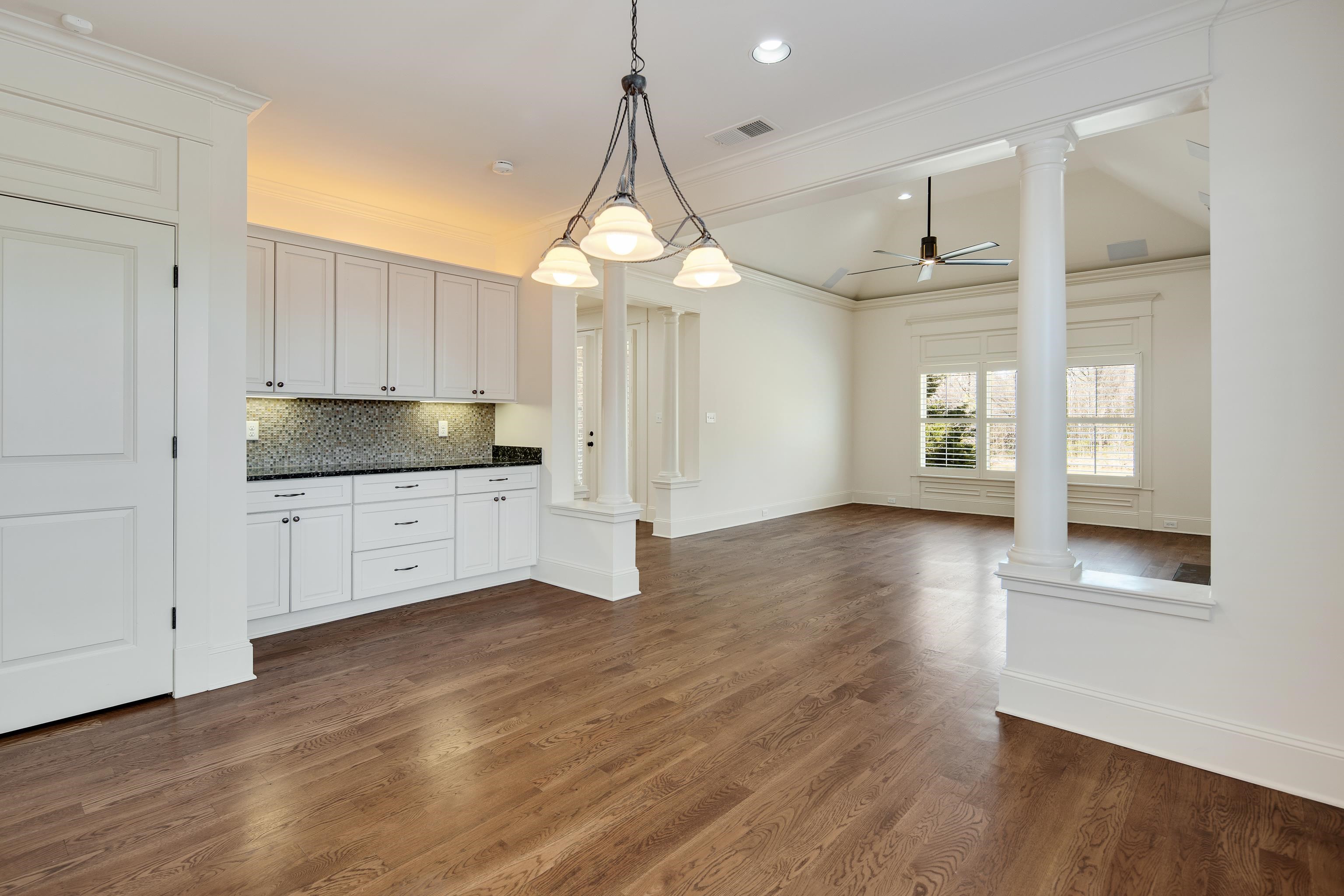 9110 Baynard Loop North Germantown, TN 38139 - Photo 16 of 40 a kitchen with granite countertop a stove a sink and white cabinets with wooden floor