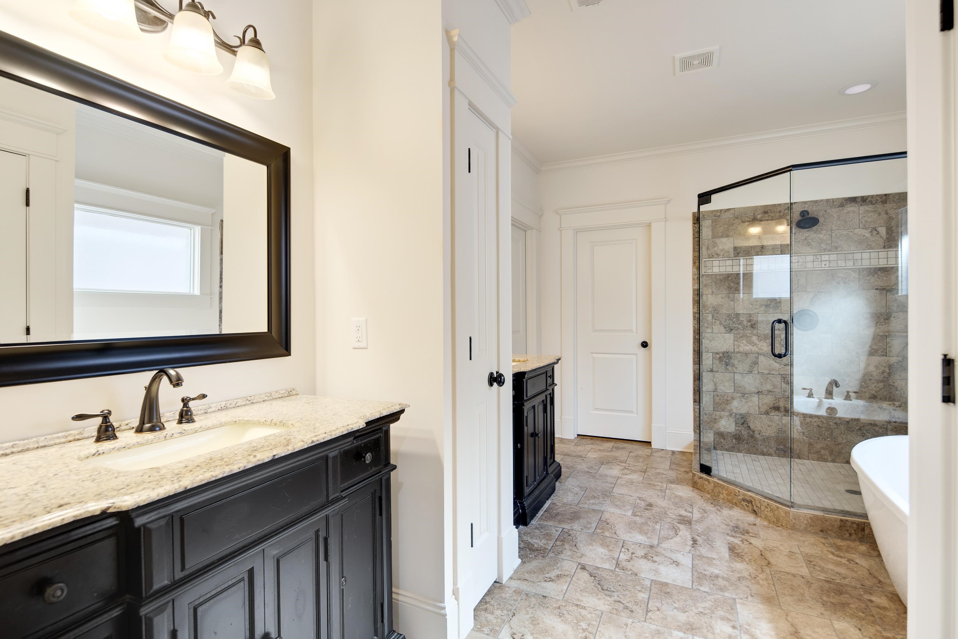 9110 Baynard Loop North Germantown, TN 38139 - Photo 23 of 40 a bathroom with a granite countertop sink mirror bathtub and shower