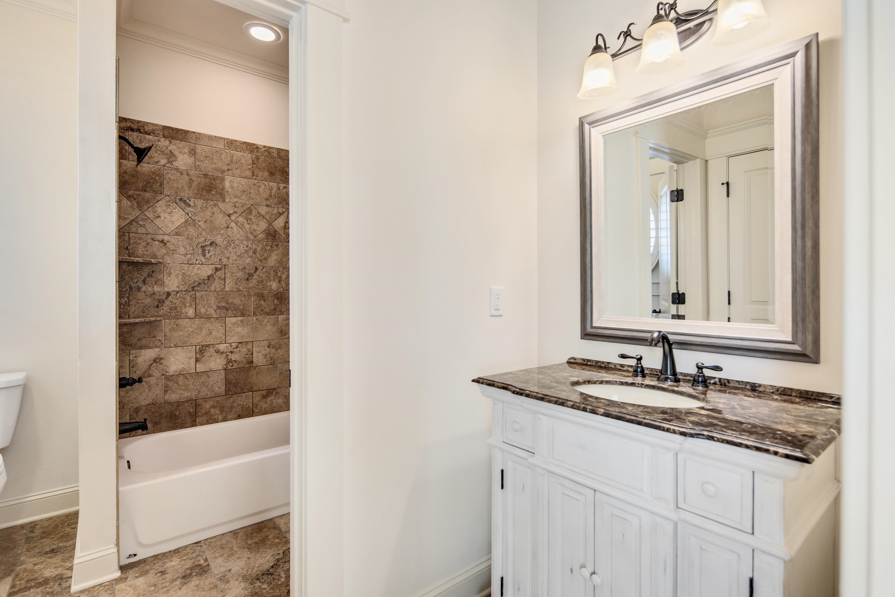 9110 Baynard Loop North Germantown, TN 38139 - Photo 28 of 40 a bathroom with a granite countertop sink and a mirror