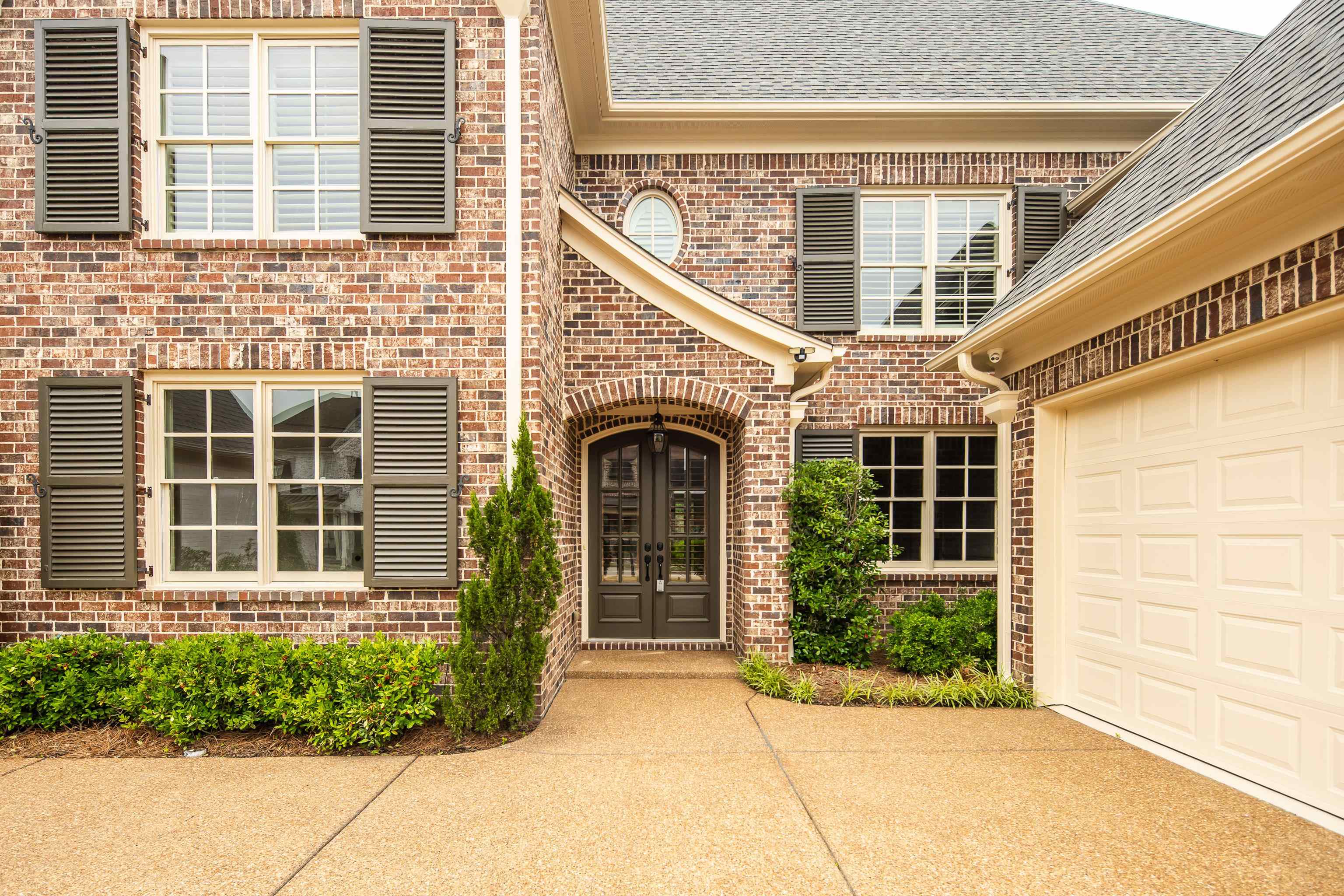 9110 Baynard Loop North Germantown, TN 38139 - Photo 3 of 40 front view of a brick house with a large windows