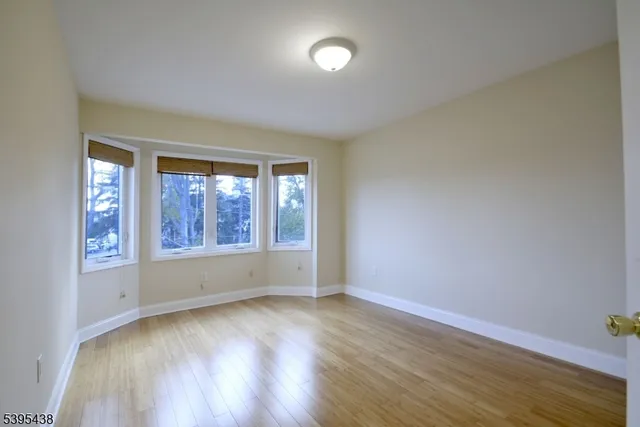 a bedroom with a bed and glass window