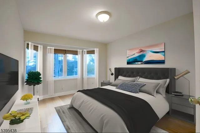 a spacious bathroom with a granite countertop sink a toilet and a mirror