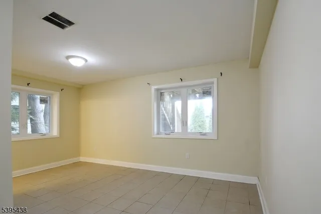 a living room with furniture a large window and a wooden floor
