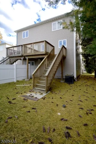 a balcony with wooden floor and fence