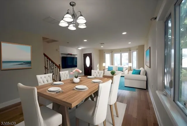 a view of a dining room with furniture wooden floor and chandelier