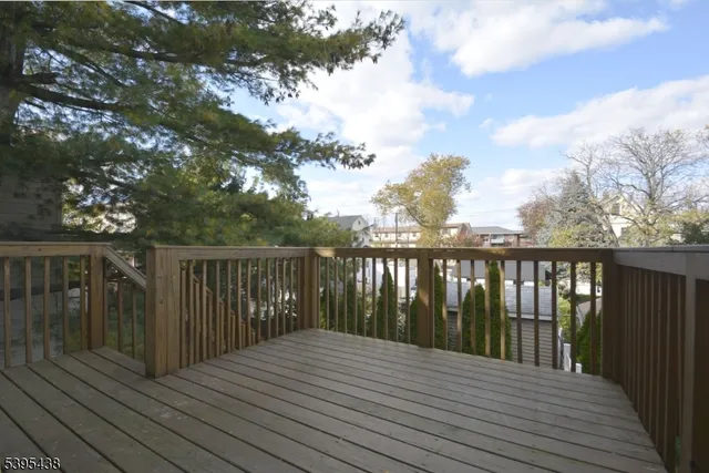 a balcony with wooden floor and fence