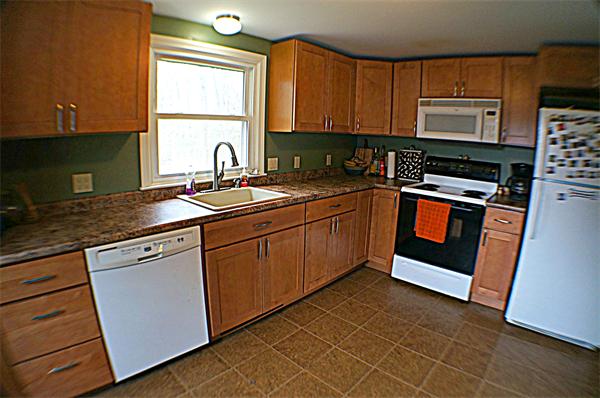 38 Toll Road Salisbury, MA 01952 - Photo 7 of 19 a kitchen with stainless steel appliances granite countertop a sink stove and microwave