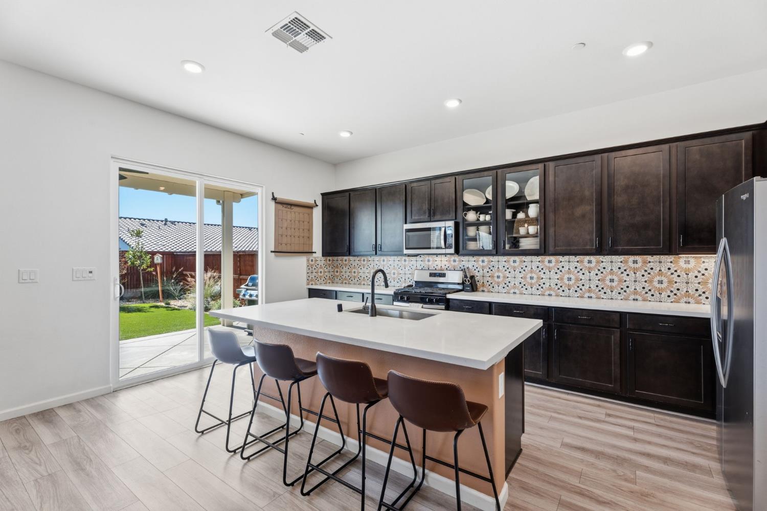 588 Overstone Avenue Madera, CA 93636 - Photo 15 of 65 a kitchen with a table and chairs in it