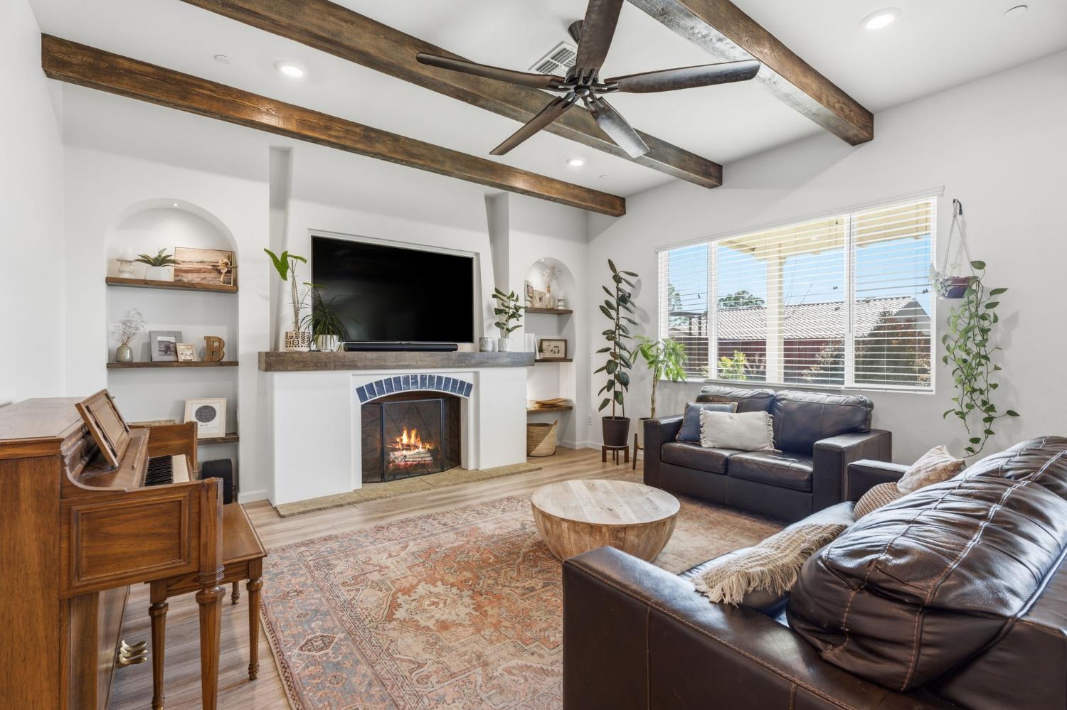 588 Overstone Avenue Madera, CA 93636 - Photo 8 of 65 a living room with furniture a fireplace and a flat screen tv