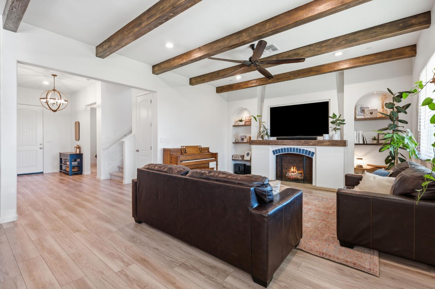 588 Overstone Avenue Madera, CA 93636 - Photo 9 of 65 a living room with furniture a flat screen tv and a fireplace