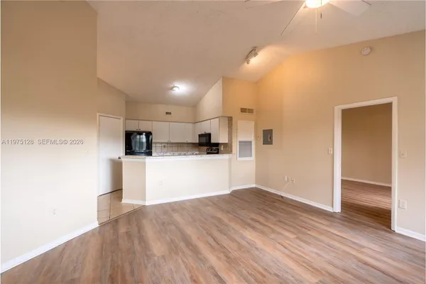 a view of kitchen with refrigerator microwave and stove