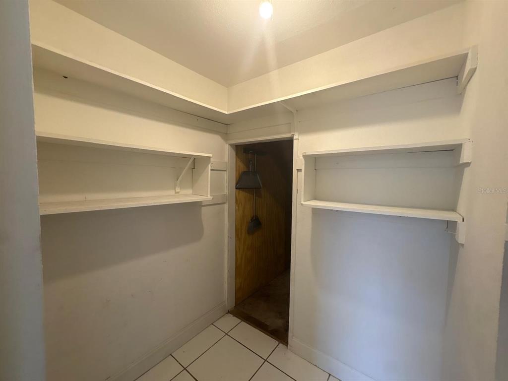 4033 Henley Road, Unit 1707 Orlando, FL 32839 - Photo 43 of 66 a room with walk in closet and wooden floor