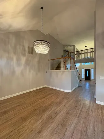 a kitchen with stainless steel appliances granite countertop a sink a stove and a refrigerator