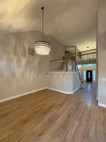 a kitchen with stainless steel appliances granite countertop a sink a stove and a refrigerator