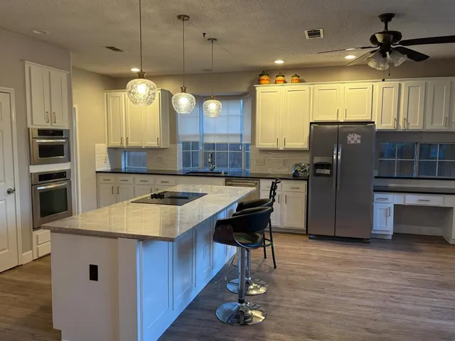 a kitchen with cabinets and appliances