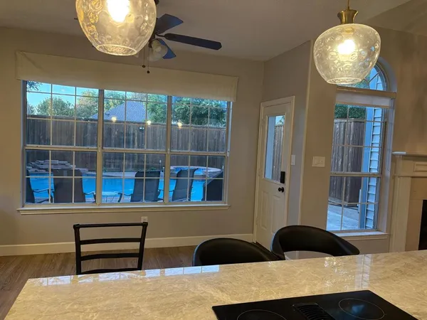 a kitchen with a table chairs and a wooden floor
