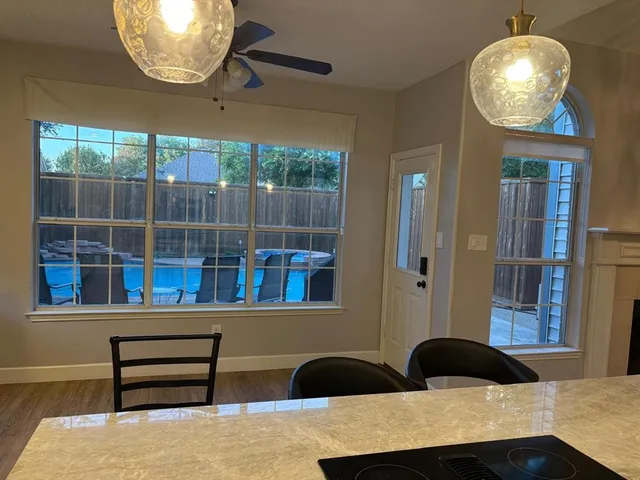 a kitchen with a table chairs and a wooden floor