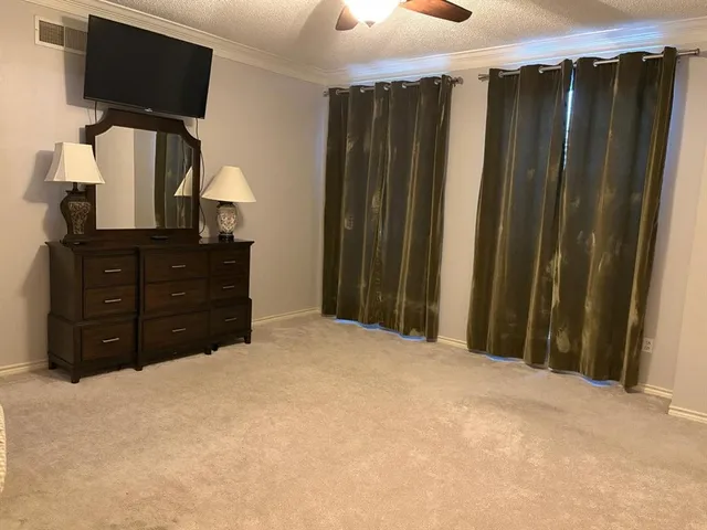 a bedroom with a bed and a flat tv screen