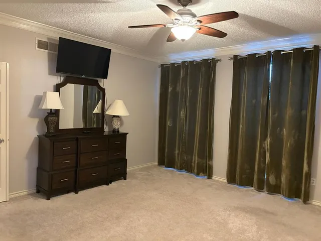 a bathroom with a granite countertop sink a mirror and a shower