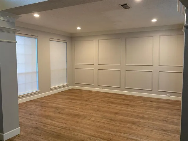 a view of a room with wooden floor