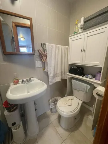 a white toilet sitting next to a bathroom sink