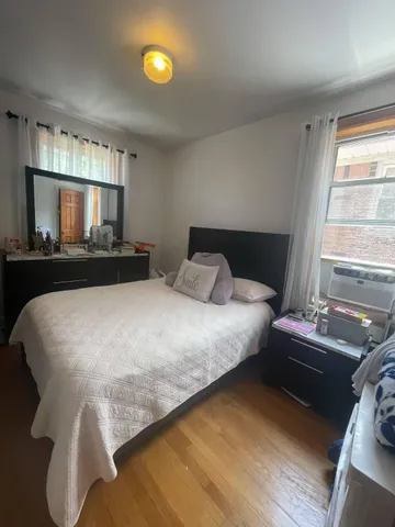 a bedroom with a bed and window