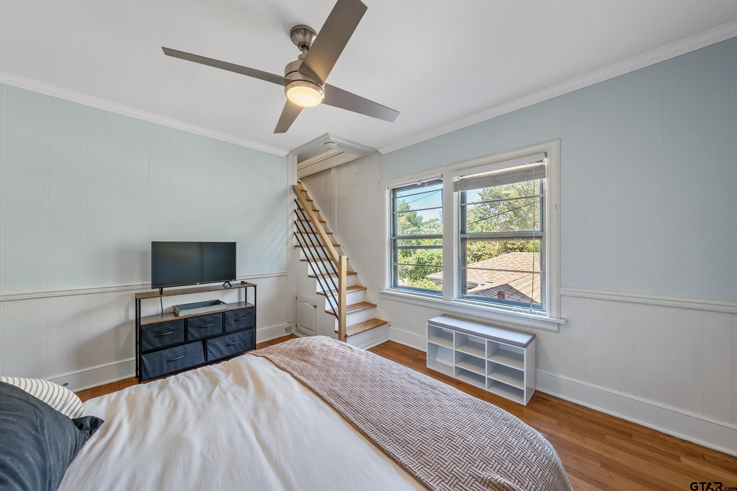 145 Rowland Place Tyler, TX 75701 - Photo 32 of 43 a bedroom with a bed and a flat screen tv