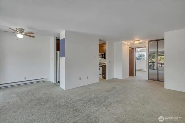 an empty room with closet and a window