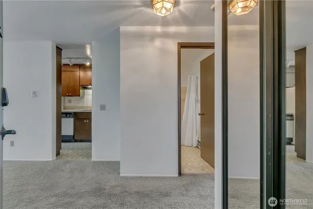 a view of a hallway with wooden floor