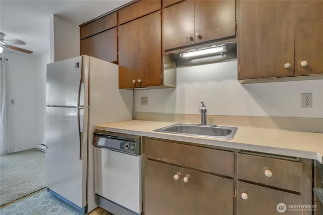 a kitchen with a sink and refrigerator