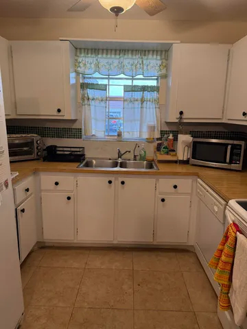 a kitchen with granite countertop a sink and a stove