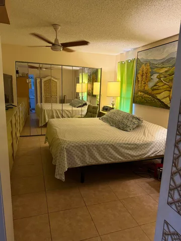 a bedroom with a bed and cabinets