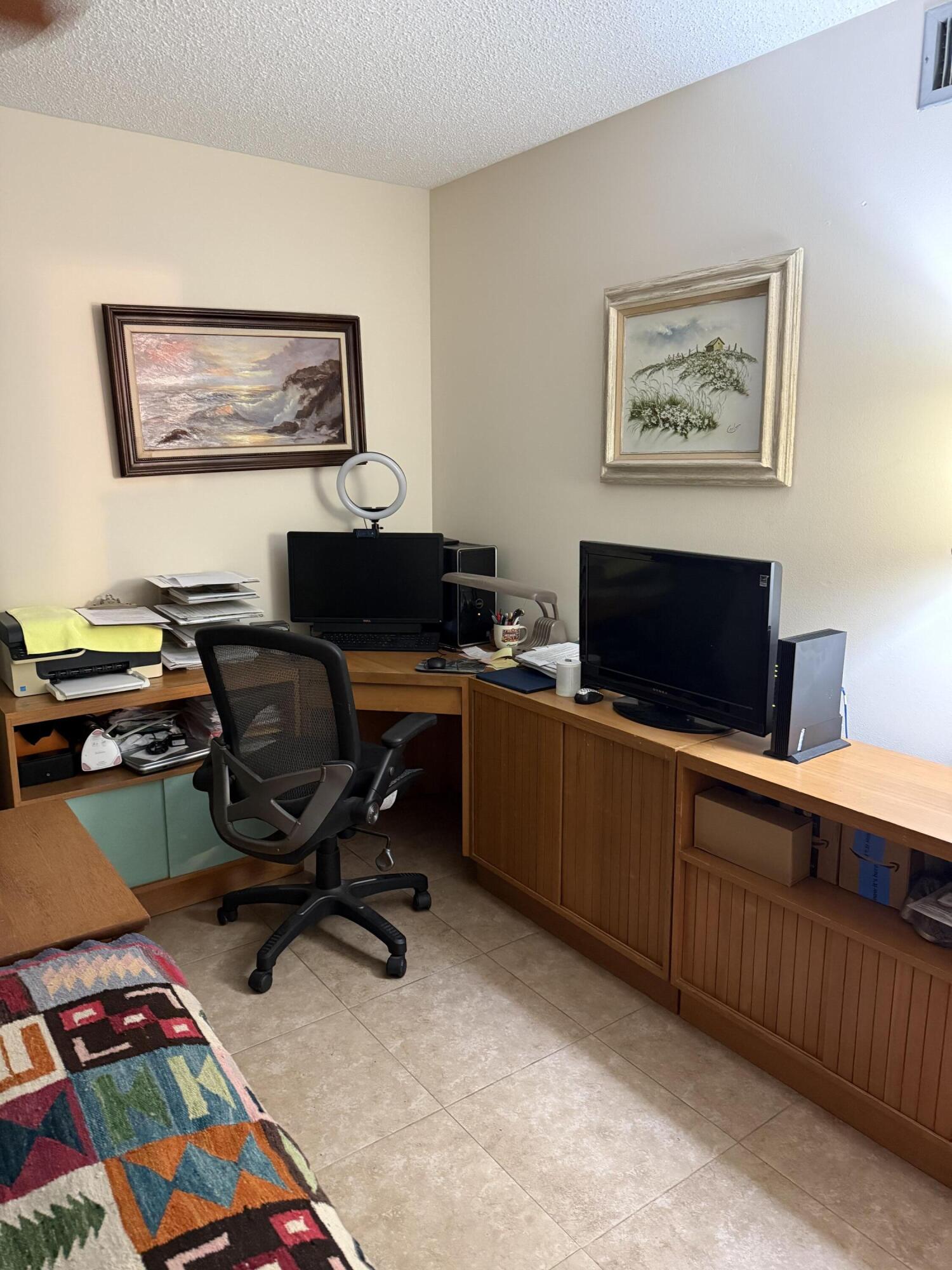 4515 Northwest 3rd Street, Unit A Delray Beach, FL 33445 - Photo 24 of 28 a view of a workspace with furniture and a window